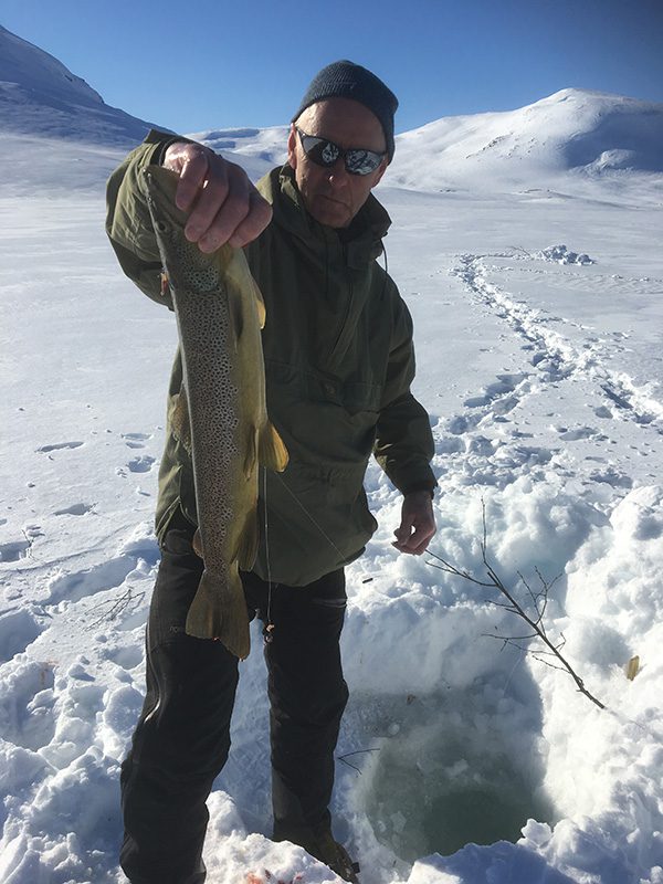 Picture of a man who got fish by ice fishing